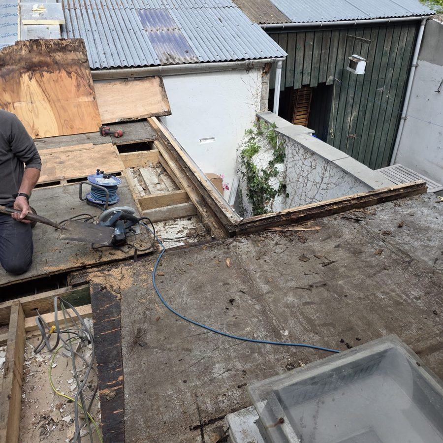 Old flat roof stripped back to bare timber decking before replacement